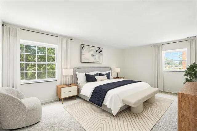 a bedroom with a bed couch and window