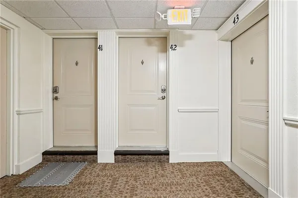 a view of room with walk in closet and wooden floor