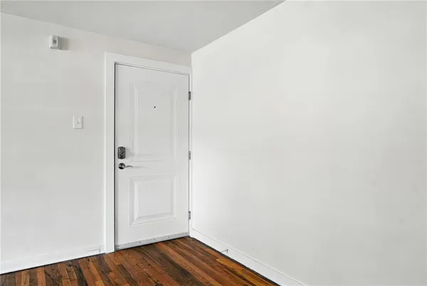 a view of room with wooden floor