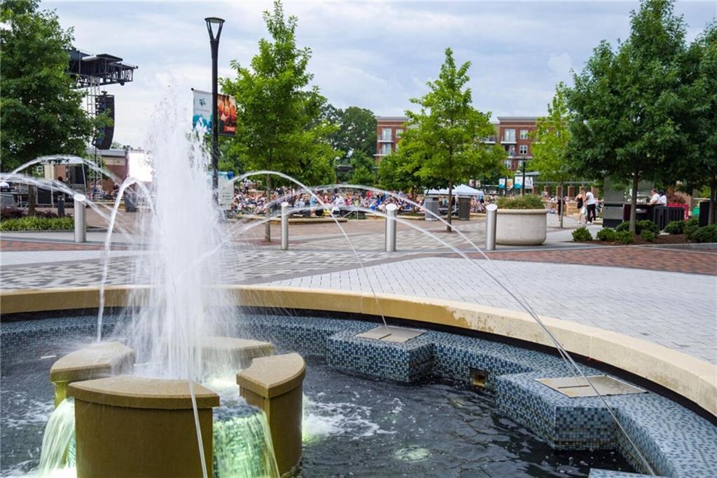 318 Sandy Springs Circle, Unit 220 Sandy Springs, GA 30328 - Photo 12 of 22 a view of a patio with couches and a table and chairs with wooden fence
