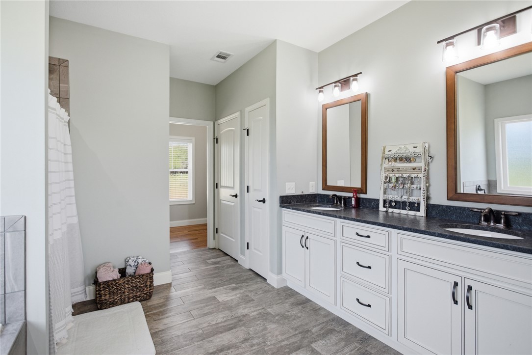 426 Oak Creek Road Seneca, SC 29678 - Photo 18 of 50 This spacious bathroom offers dual vanities and modern tile flooring, creating a functional and stylish retreat.