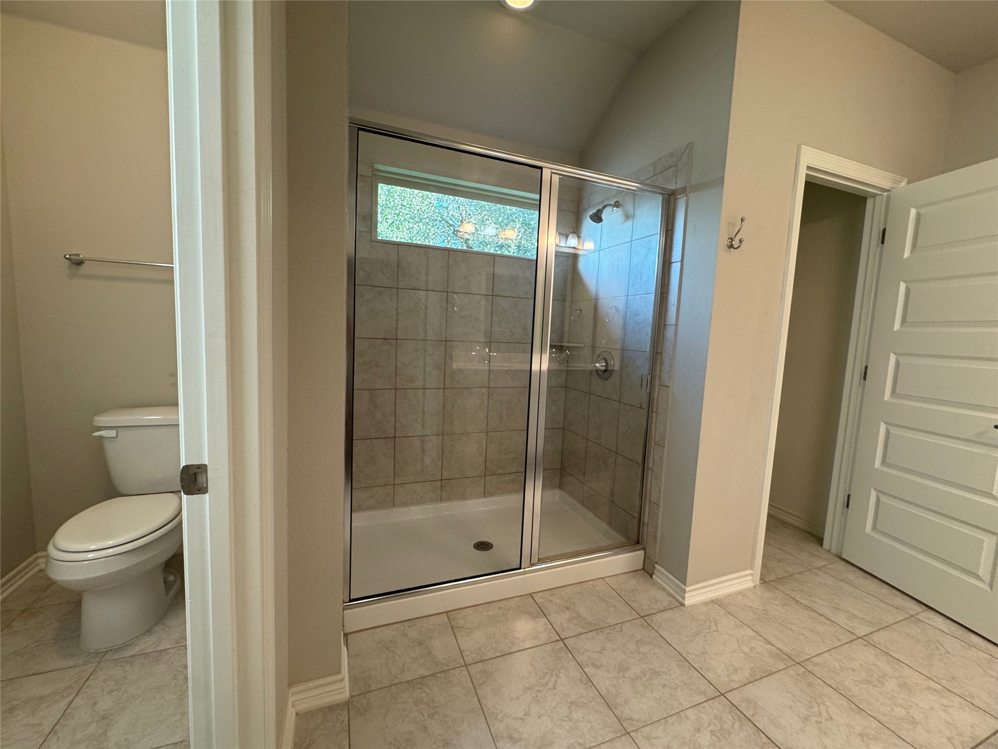14100 McCoy Loop, Unit 1 Austin, TX 78717 - Photo 20 of 39 A well-lit bathroom provides a tiled walk-in shower and separate water closet for comfort and privacy.