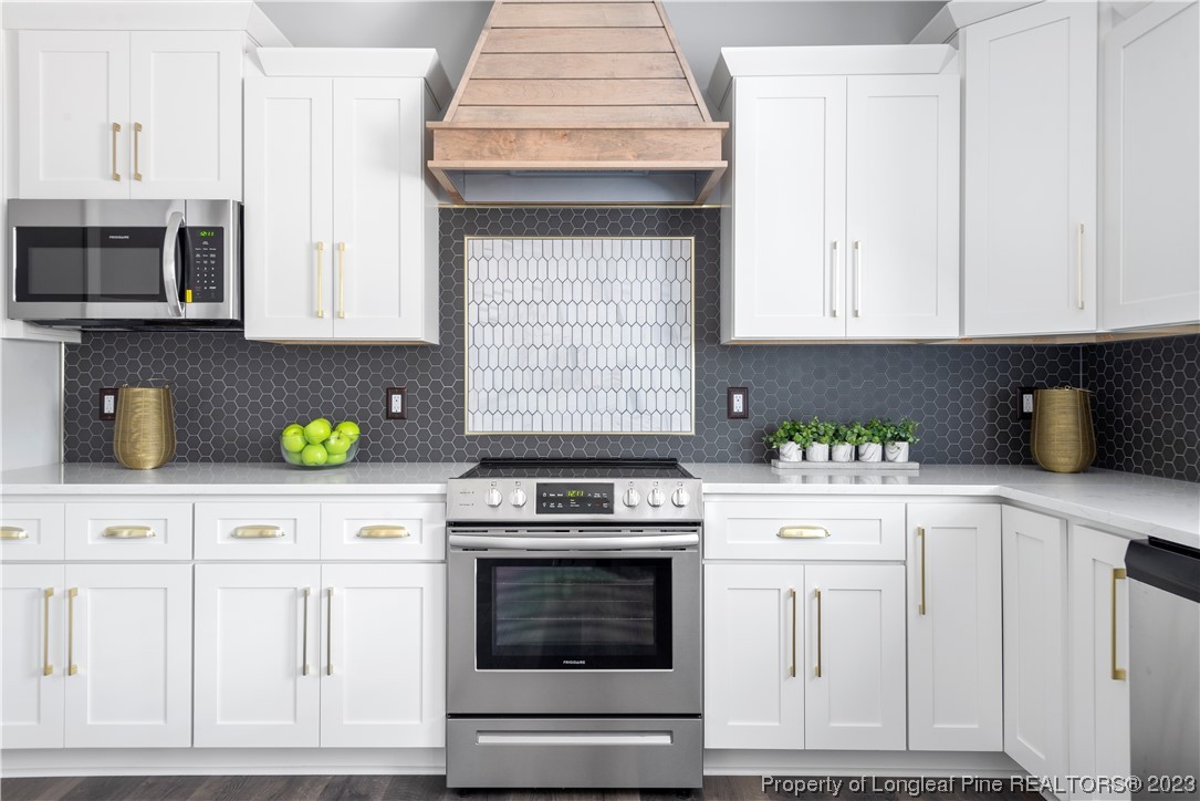 100 Sears Drive Cameron, NC 28326 - Photo 11 of 27 a kitchen with white cabinets and appliances