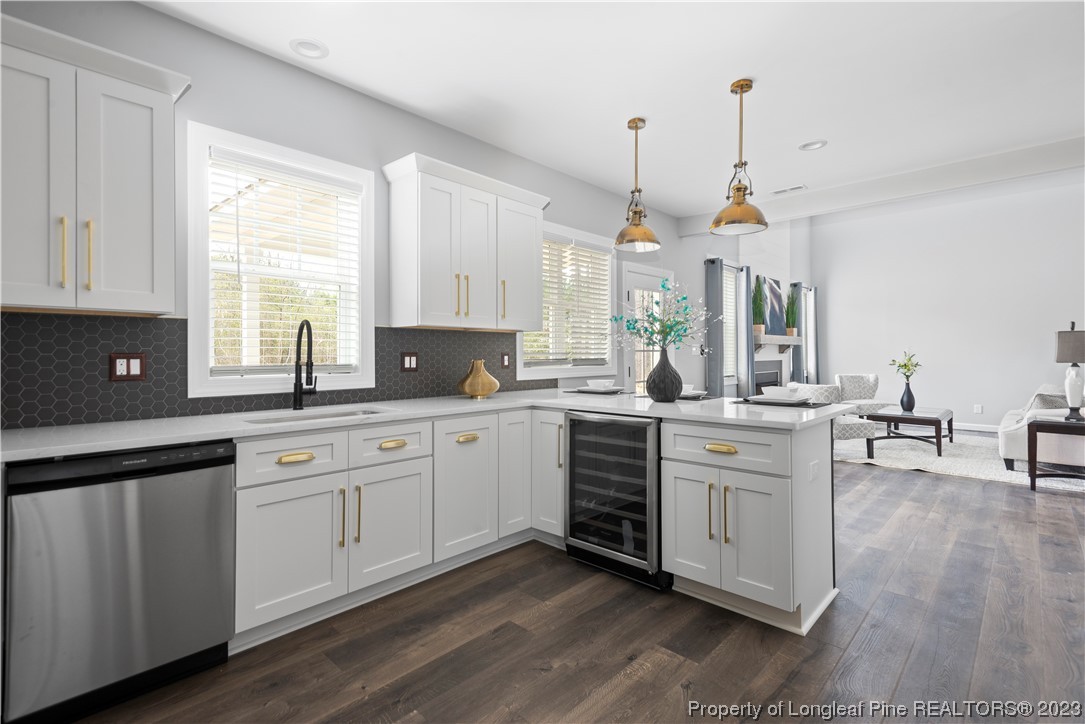 100 Sears Drive Cameron, NC 28326 - Photo 13 of 27 a kitchen with stainless steel appliances granite countertop white cabinets a sink a stove a dining table and chairs