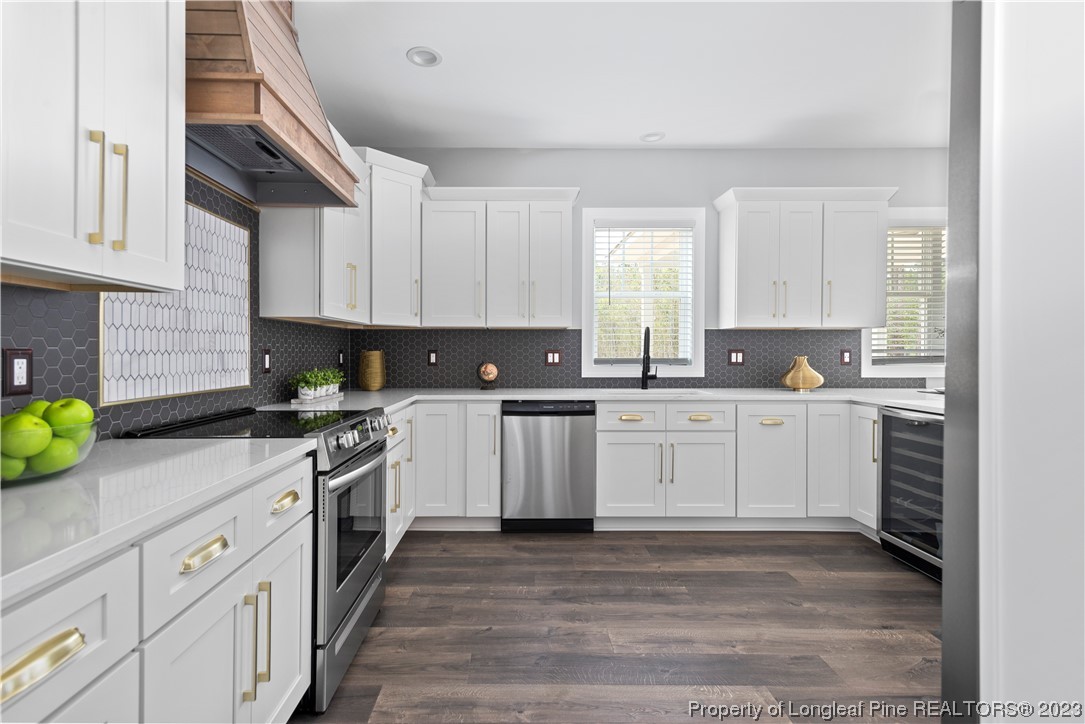 100 Sears Drive Cameron, NC 28326 - Photo 15 of 27 a kitchen with granite countertop white cabinets and stainless steel appliances