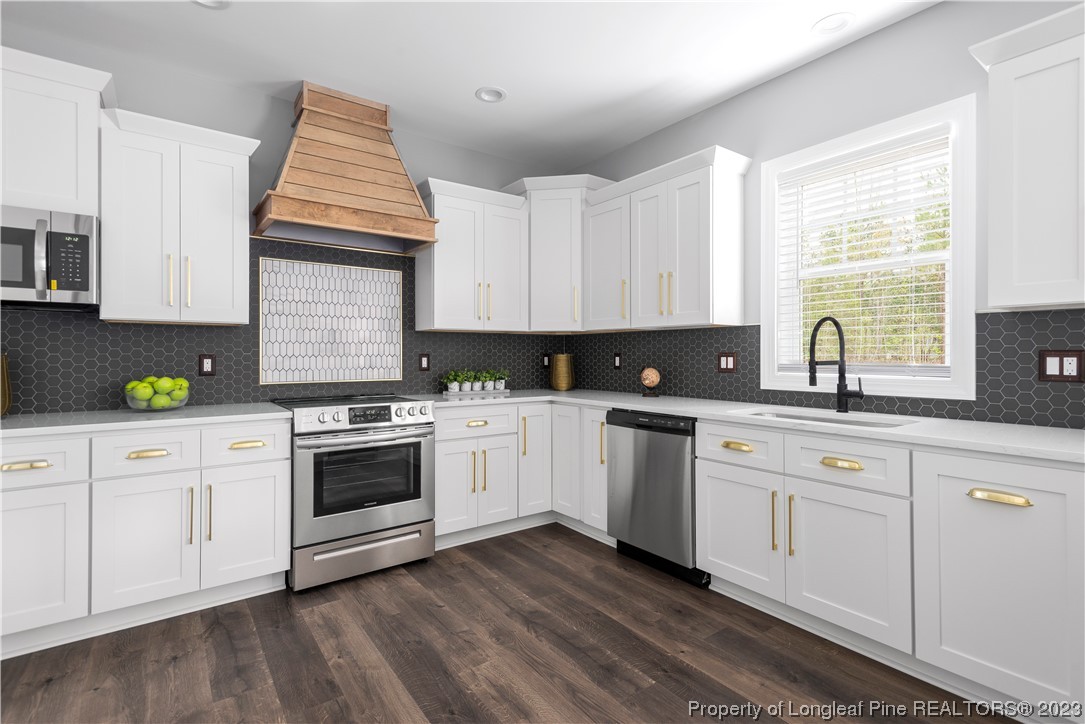 100 Sears Drive Cameron, NC 28326 - Photo 10 of 27 a kitchen with white cabinets sink and appliances