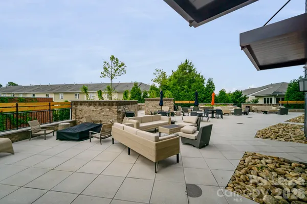 a view of a patio with couches and potted plants