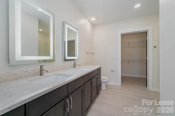 a bathroom with a double vanity sink and mirror