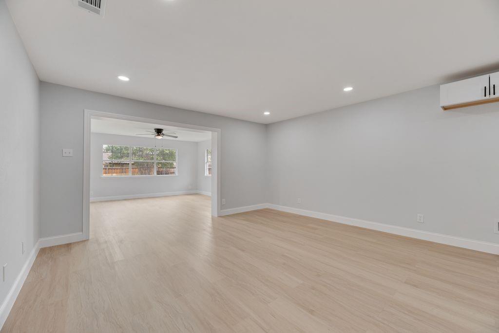 2015 Rose Hill Road Carrollton, TX 75007 - Photo 11 of 19 wooden floor in an empty room with a window