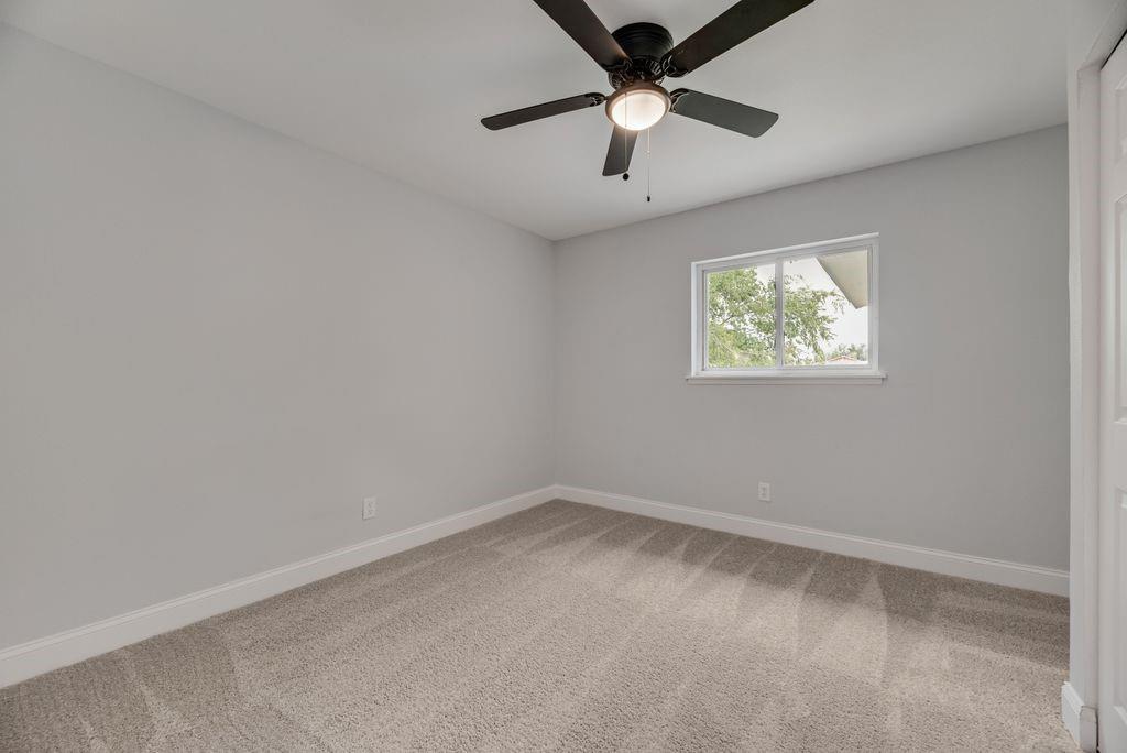 2015 Rose Hill Road Carrollton, TX 75007 - Photo 13 of 19 an empty room with windows and fan