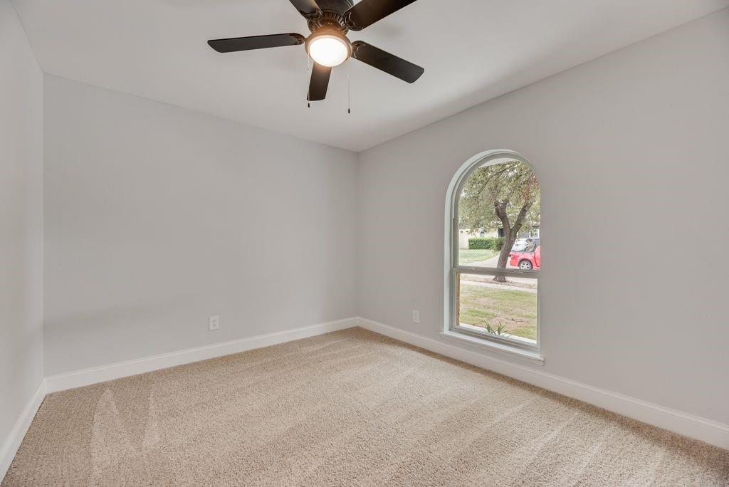 2015 Rose Hill Road Carrollton, TX 75007 - Photo 14 of 19 an empty room with ceiling fan and window