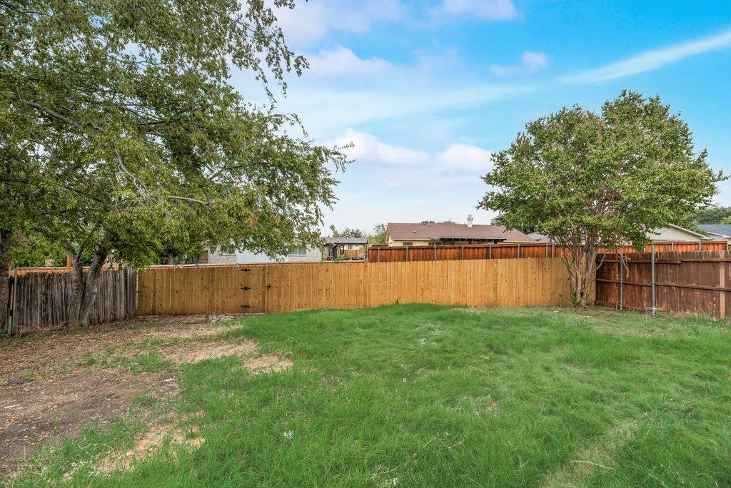 2015 Rose Hill Road Carrollton, TX 75007 - Photo 17 of 19 a view of a backyard of the house
