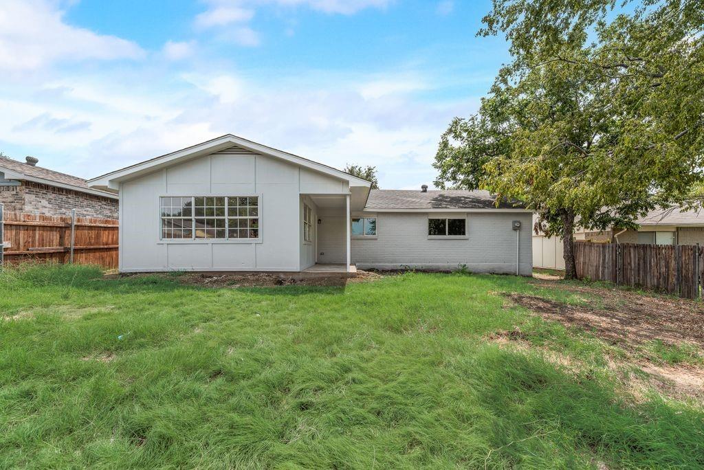 2015 Rose Hill Road Carrollton, TX 75007 - Photo 18 of 19 a view of an house with backyard space and garden