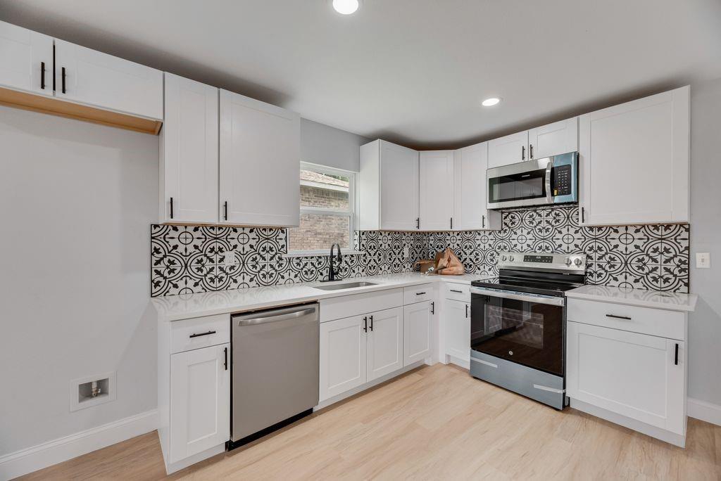 2015 Rose Hill Road Carrollton, TX 75007 - Photo 5 of 19 a kitchen with granite countertop cabinets stainless steel appliances and a sink