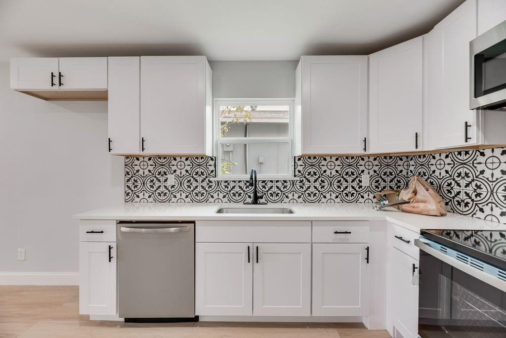 2015 Rose Hill Road Carrollton, TX 75007 - Photo 6 of 19 a kitchen with white cabinets and sink