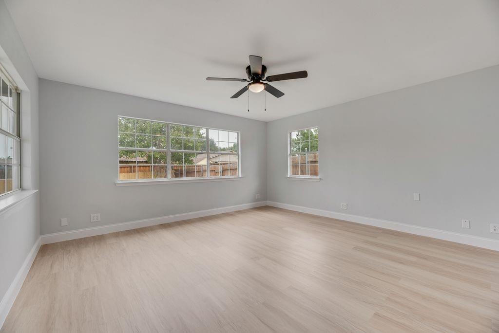 2015 Rose Hill Road Carrollton, TX 75007 - Photo 8 of 19 wooden floor in an empty room with a window