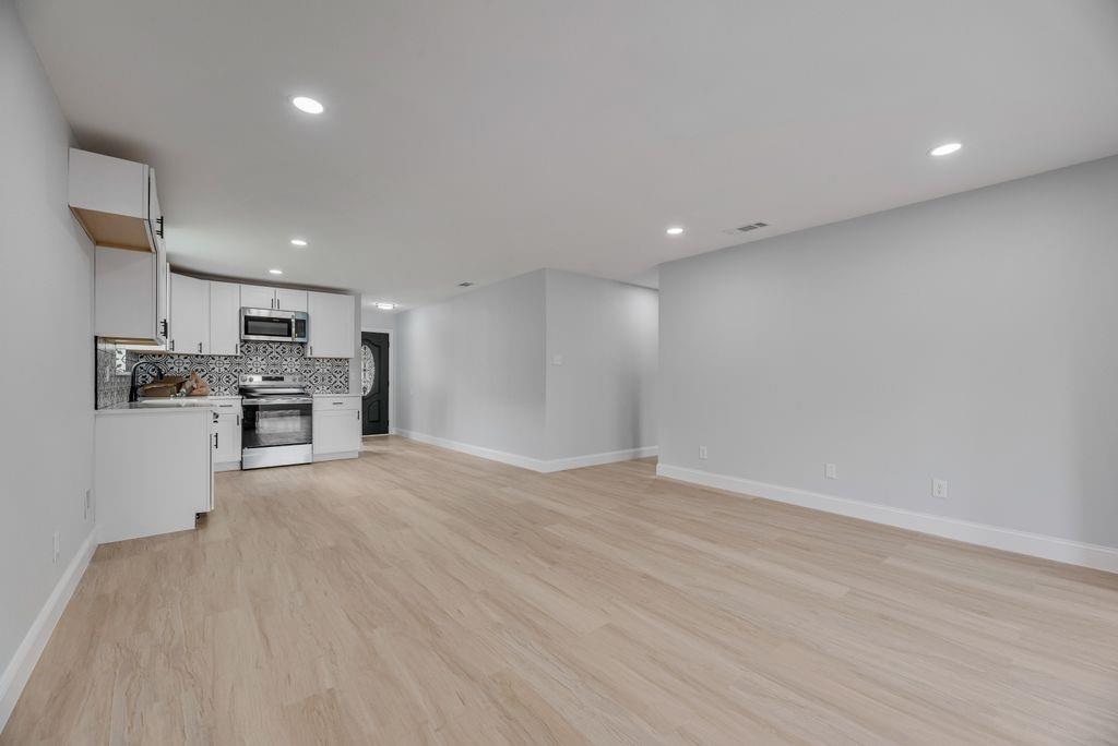 2015 Rose Hill Road Carrollton, TX 75007 - Photo 10 of 19 a view of kitchen with kitchen island a sink wooden floor and stainless steel appliances