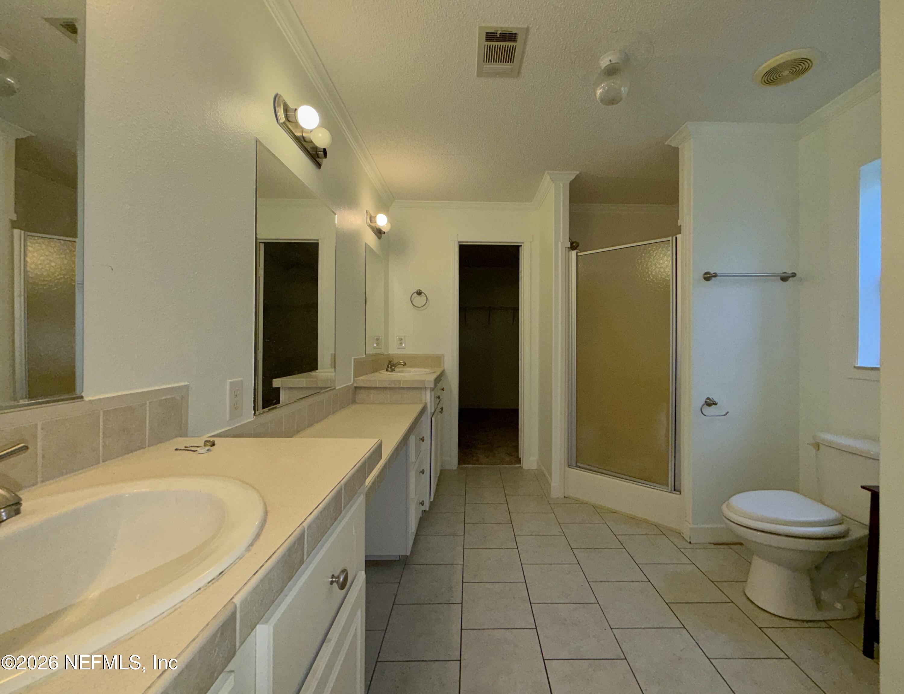 136 Short Pine Road Hawthorne, FL 32640 - Photo 19 of 39 a spacious bathroom with a granite countertop sink a toilet and a large mirror