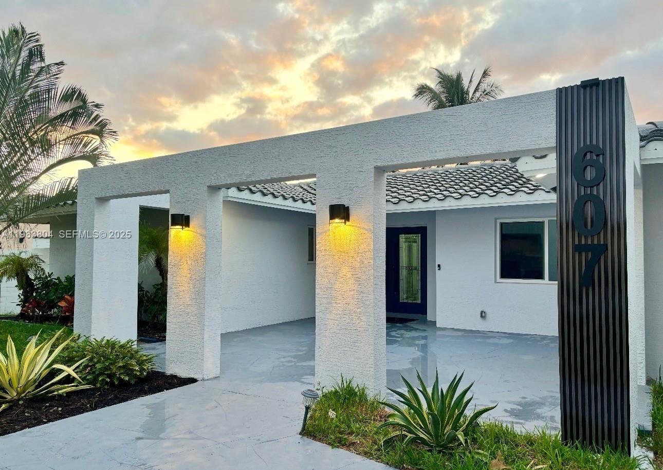 607 Maple Drive Margate, FL 33063 - Photo 1 of 37 a front view of a house with garden