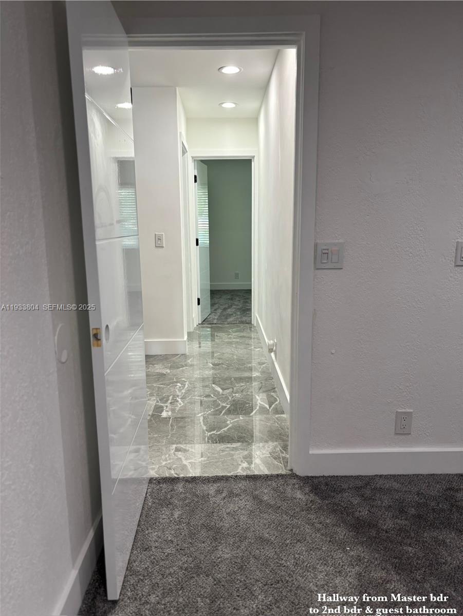 607 Maple Drive Margate, FL 33063 - Photo 15 of 37 a view of a bathroom with a glass door shower