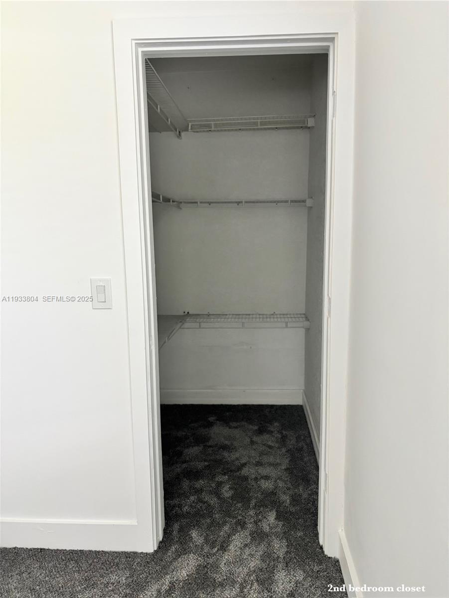 607 Maple Drive Margate, FL 33063 - Photo 20 of 37 a room with a bench