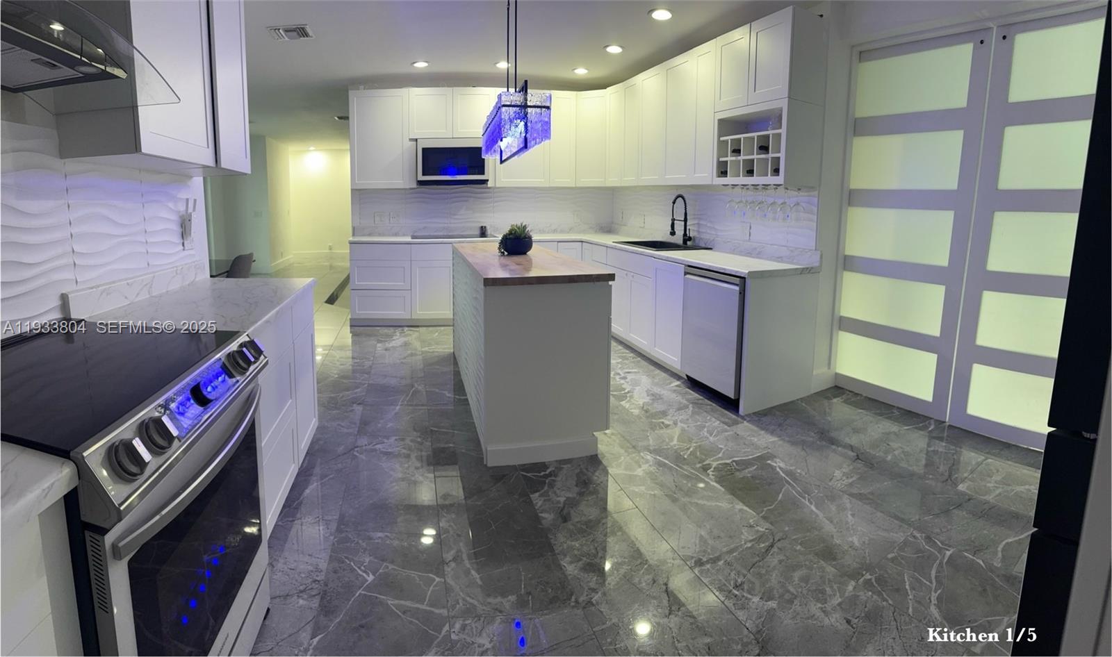 607 Maple Drive Margate, FL 33063 - Photo 24 of 37 a kitchen with granite countertop a sink a stove and a refrigerator