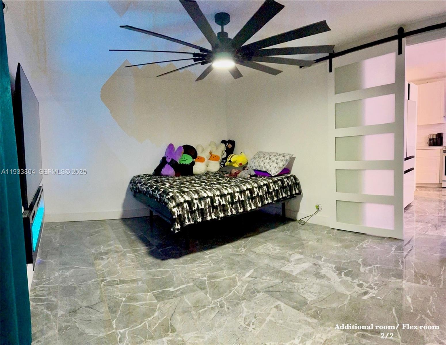 607 Maple Drive Margate, FL 33063 - Photo 33 of 37 a room with a bed and a ceiling fan