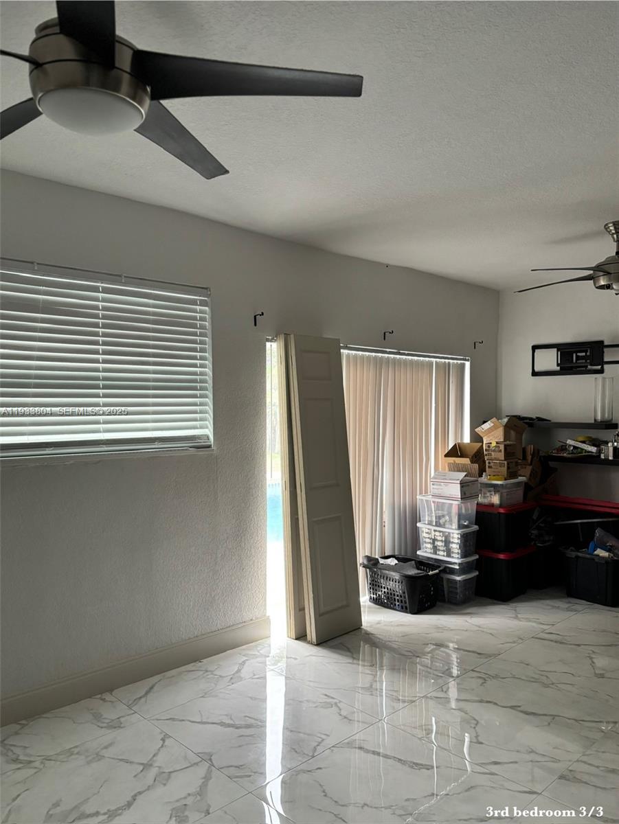 607 Maple Drive Margate, FL 33063 - Photo 36 of 37 a living room with furniture and a fireplace