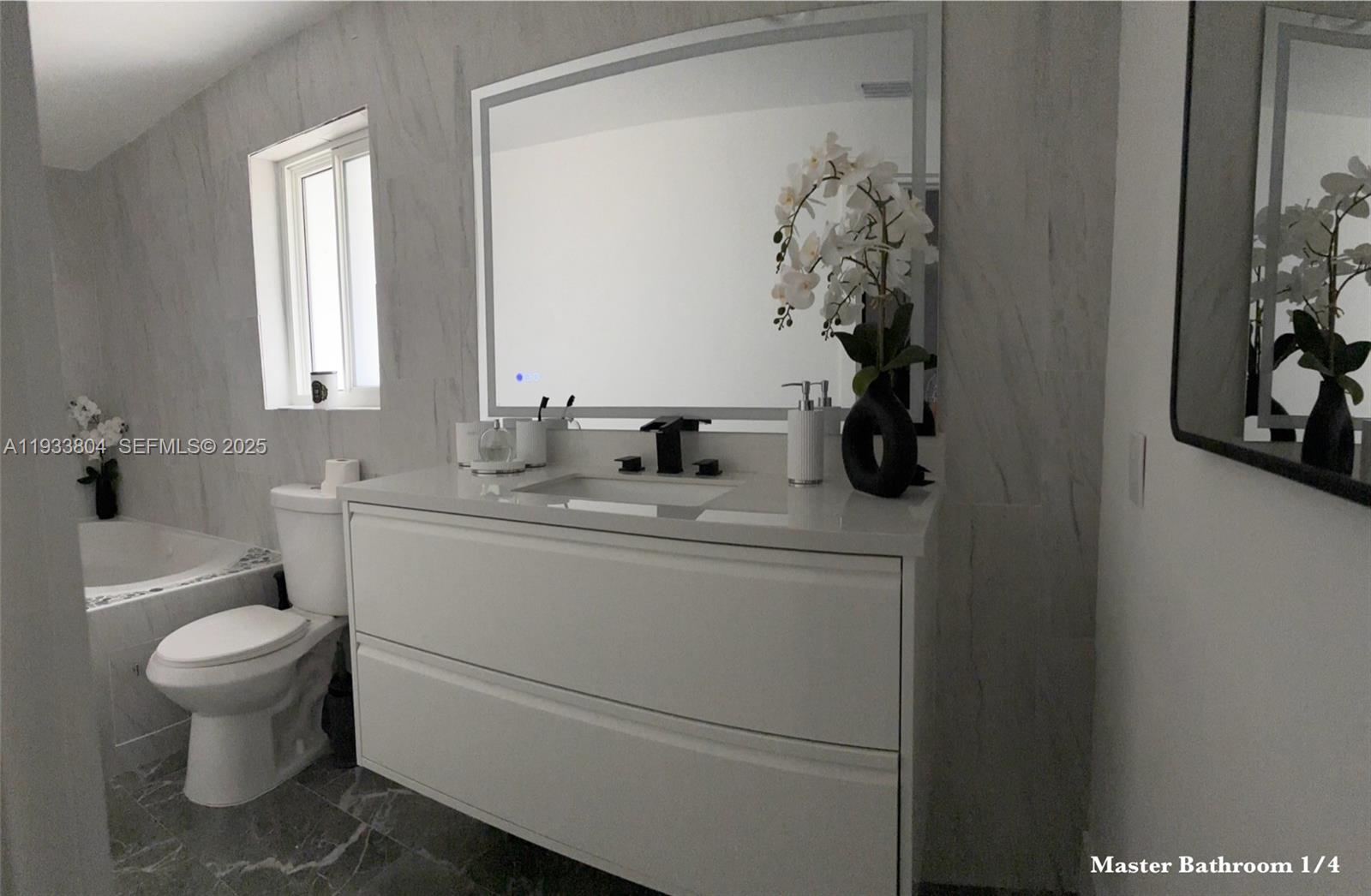 607 Maple Drive Margate, FL 33063 - Photo 5 of 37 a bathroom with a toilet a sink and mirror