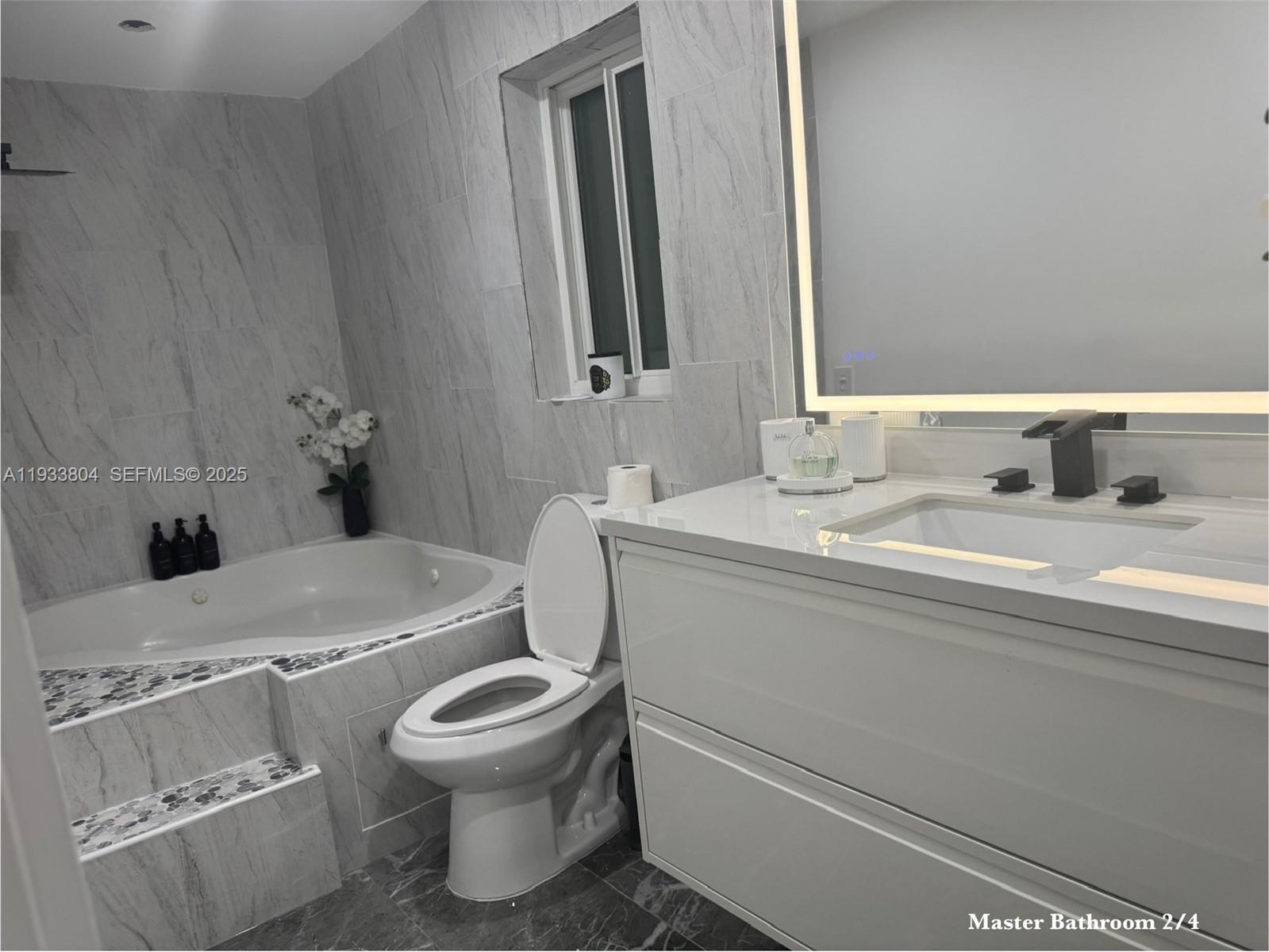 607 Maple Drive Margate, FL 33063 - Photo 6 of 37 a bathroom with a toilet sink and mirror