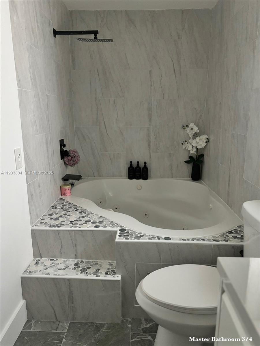 607 Maple Drive Margate, FL 33063 - Photo 7 of 37 a bathroom with a toilet and a sink