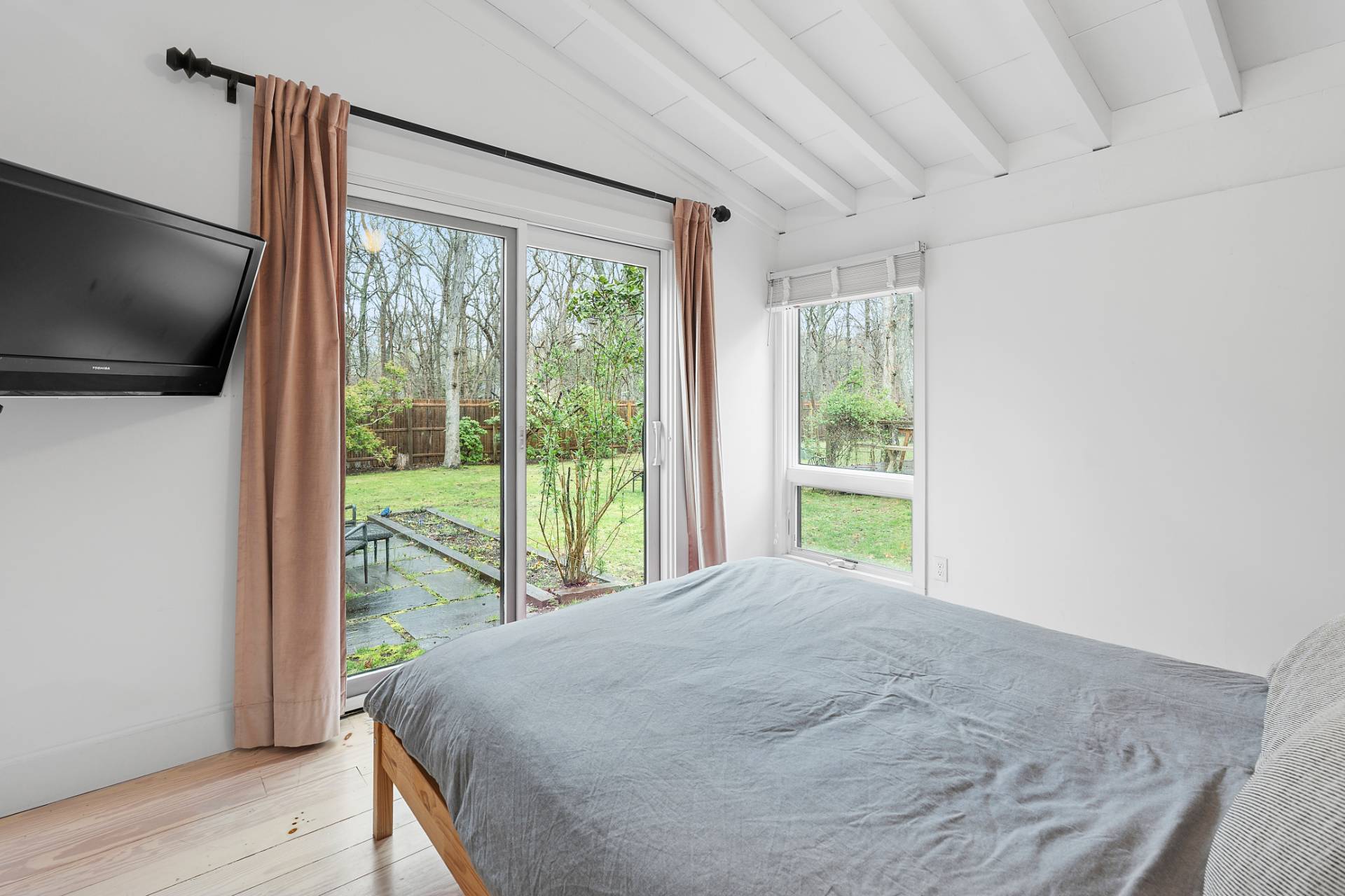 6 Beverly Road East Hampton, NY 11937 - Photo 7 of 12 a bed sitting in a bedroom next to a window
