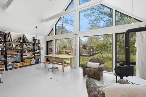 a living room with furniture and a floor to ceiling window