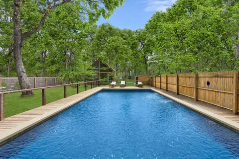 a view of a yard with wooden fence