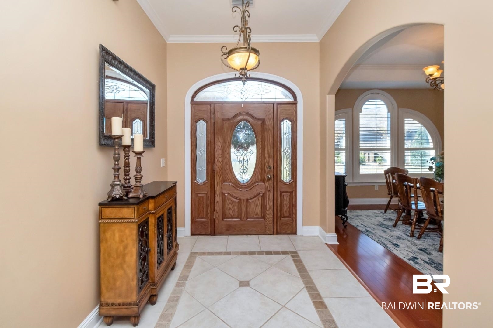 9905 Carnoustie Court Foley, AL 36535 - Photo 2 of 31 Entryway featuring inlaid floor details, ornamental molding, arched walkways, and light tile patterned floors
