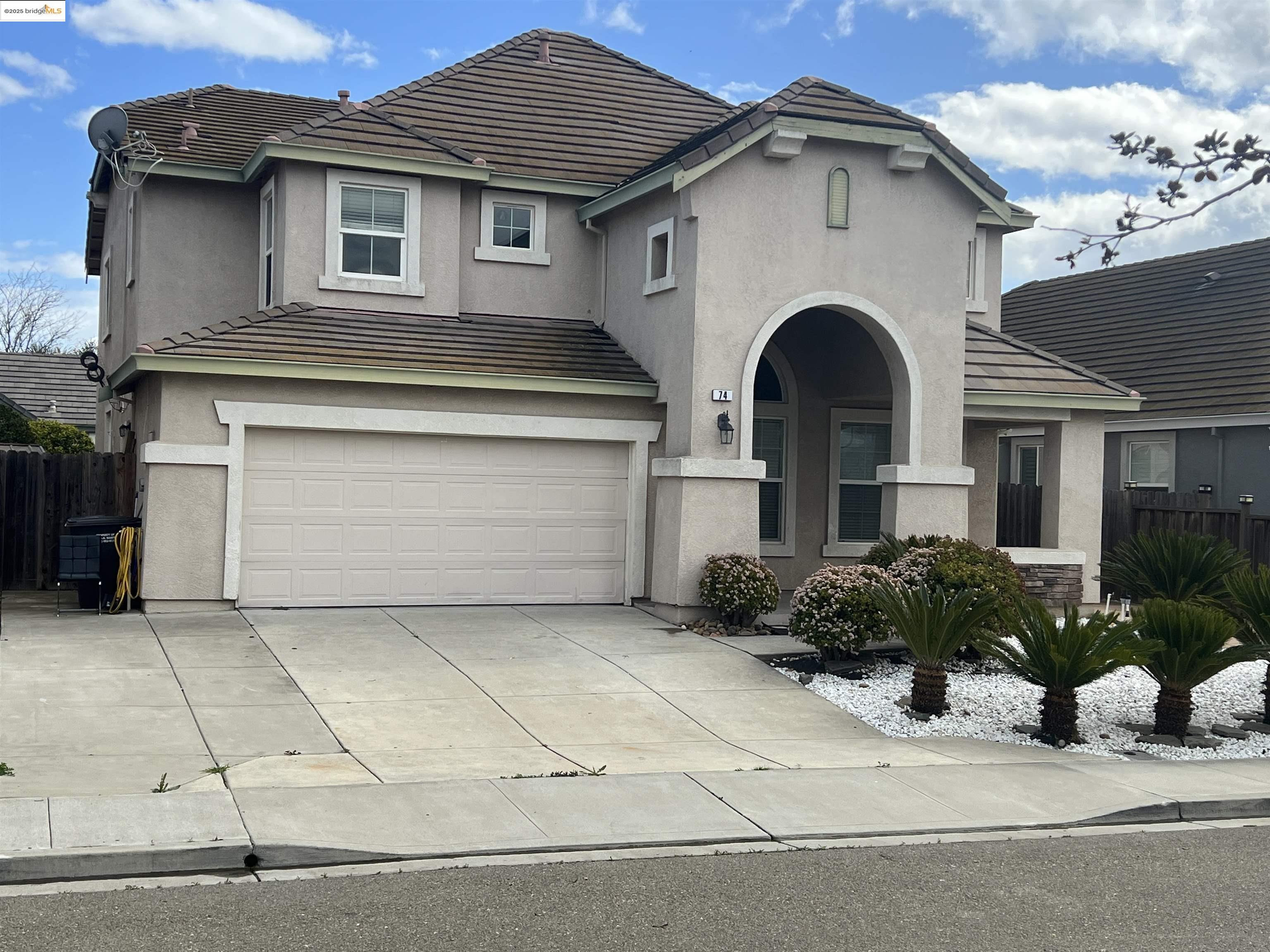 74 Vella Circle Oakley, CA 94561 - Photo 1 of 15 a front view of a house with garden