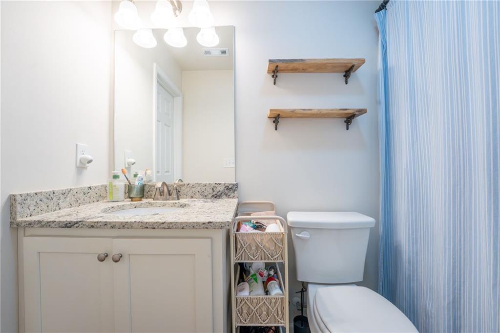 118 Wash Rider Road Dahlonega, GA 30533 - Photo 25 of 37 a bathroom with a granite countertop toilet sink and mirror