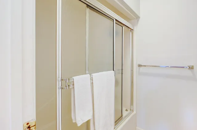 a bathroom with a shower and a door