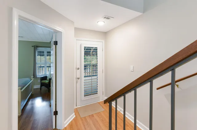 a view of an entryway with wooden floor and windows