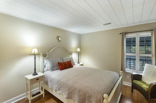 a bedroom with a bed and a large window