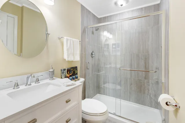 a bathroom with a sink toilet and shower