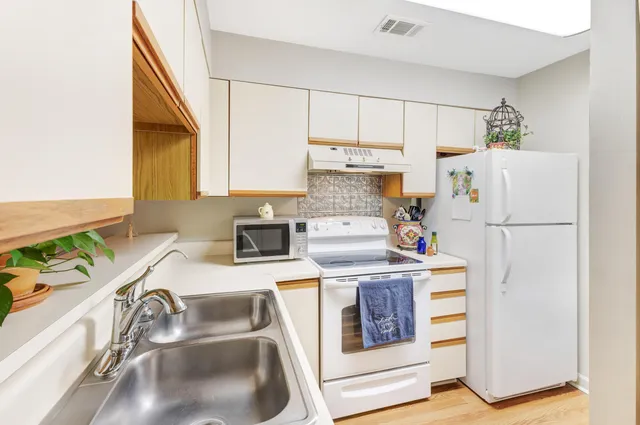 a kitchen with a sink a stove and refrigerator
