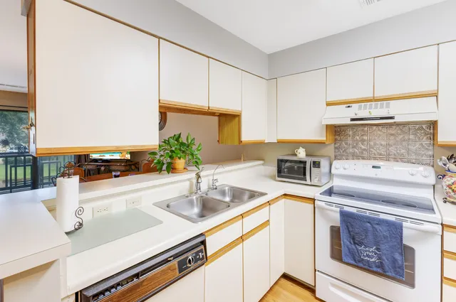 a kitchen with a sink and a refrigerator