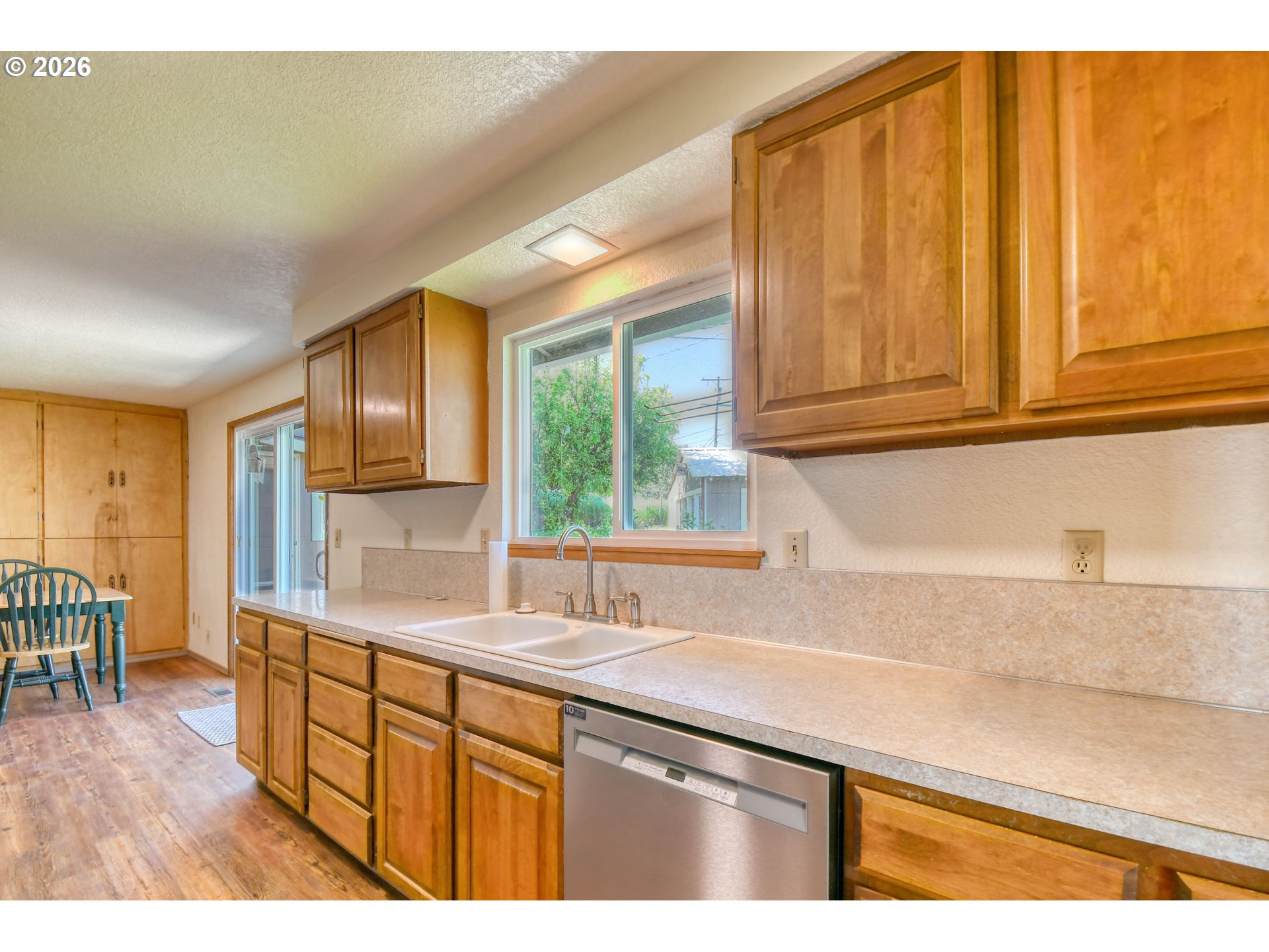 1107 Southwest 23rd Street Pendleton, OR 97801 - Photo 16 of 42 a kitchen with stainless steel appliances granite countertop a sink dishwasher cabinets and next to a window