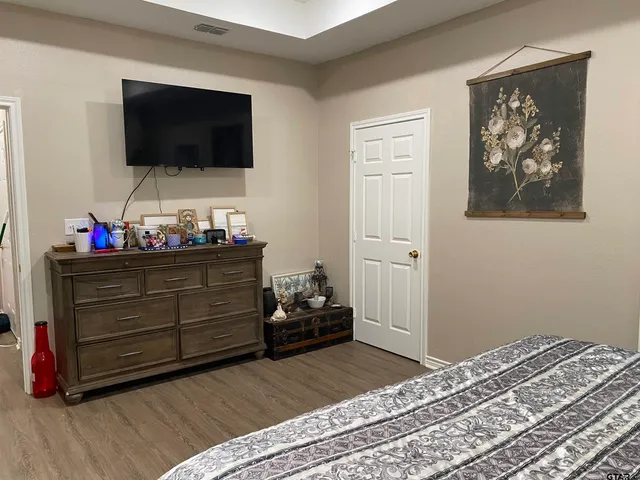 a bedroom with a bed and flat screen tv