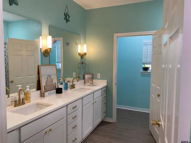 a bathroom with a double vanity sink and a mirror