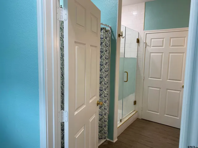 a bathroom with a shower and a glass door