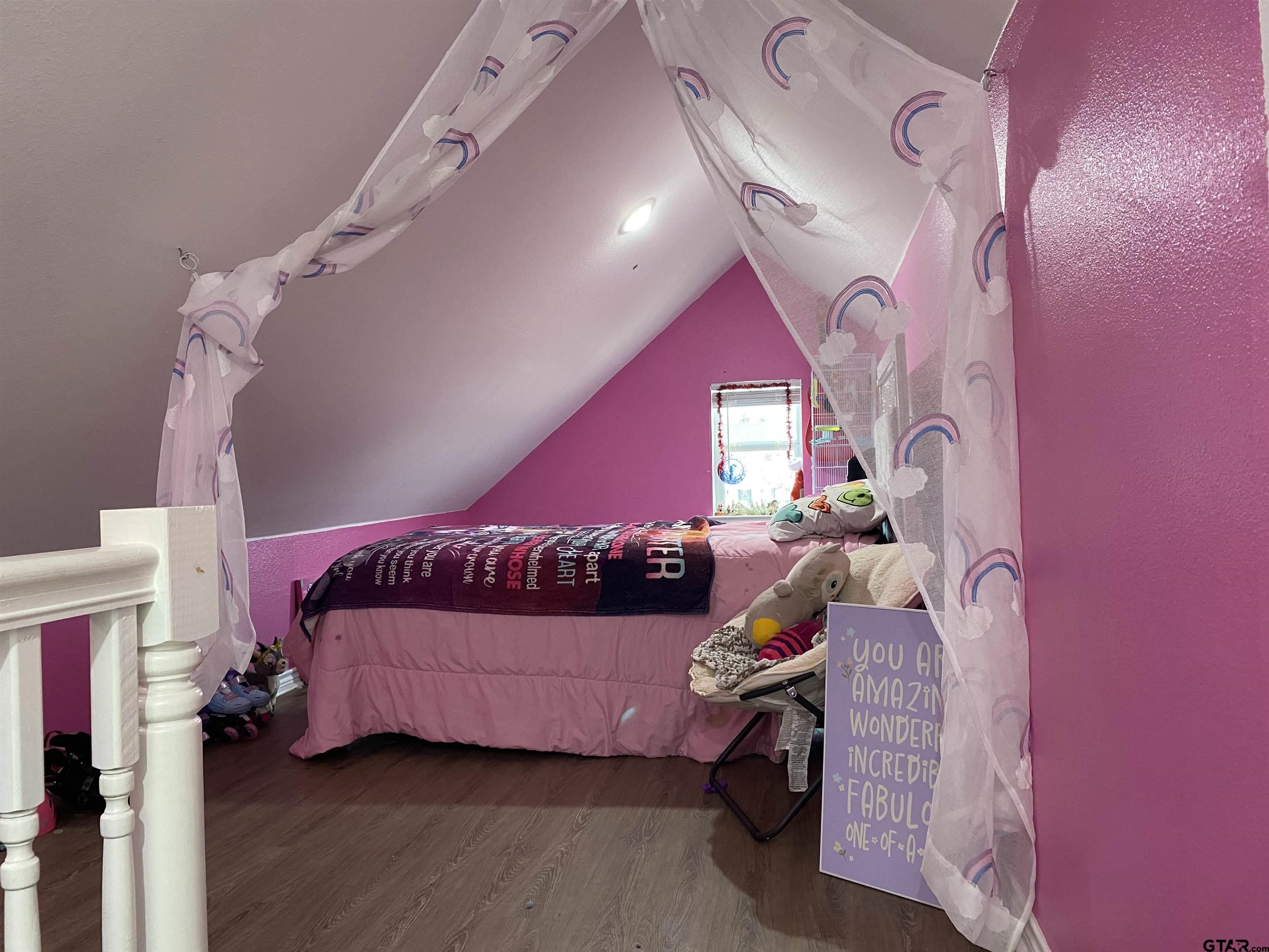 14965 Turtle Crk Rnch Road Flint, TX 75762 - Photo 17 of 22 a bedroom with a bed and a chandelier