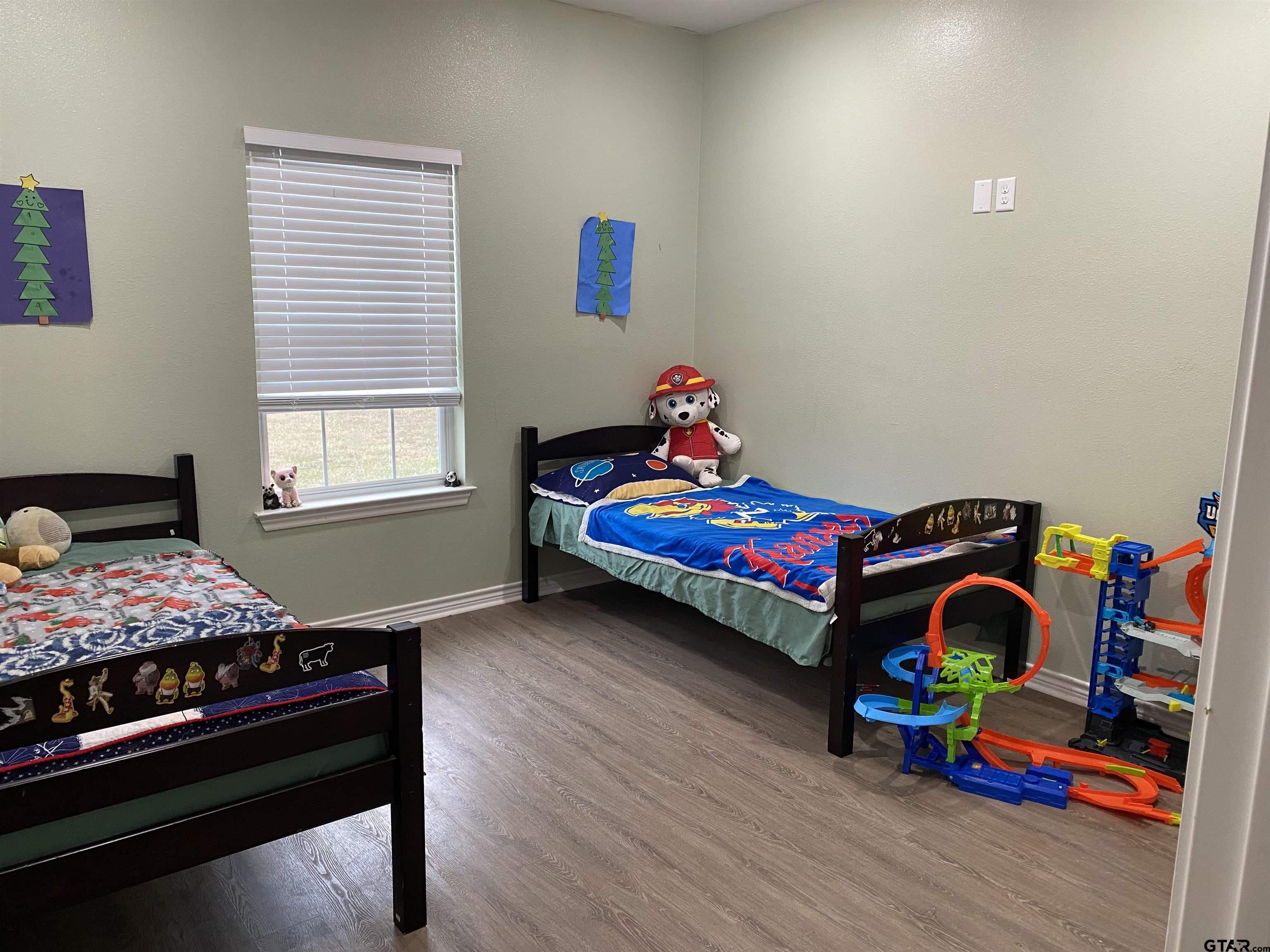 14965 Turtle Crk Rnch Road Flint, TX 75762 - Photo 19 of 22 a bedroom with a bed and a wooden floor