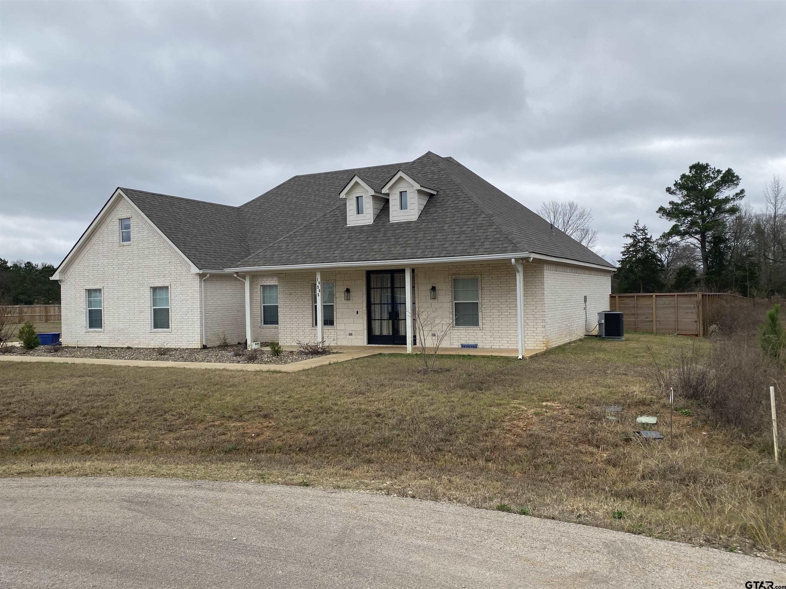 14965 Turtle Crk Rnch Road Flint, TX 75762 - Photo 5 of 22 a front view of a house with a yard and garage